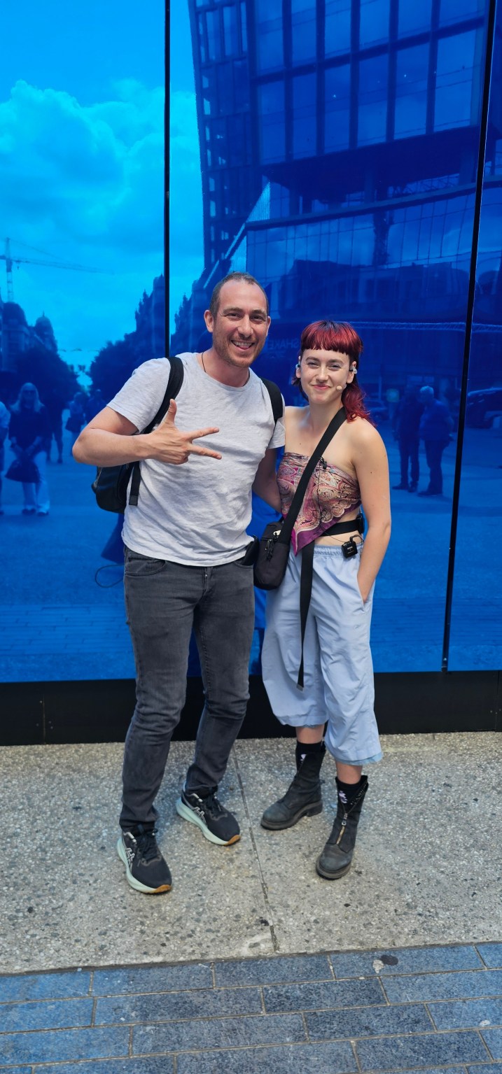 Two Fingers For - Douglas.bxl met Silke Hamers in front of PRODIGY 12, Place De brouckère, Brussels, 2026.